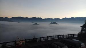 a view of a foggy valley with mountains in the background at SunSweet House in Fanlu