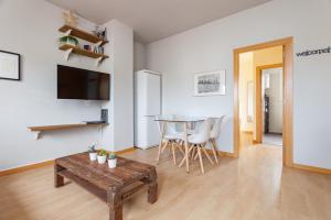 a living room with a table and a dining room at Penthouse Camp Nou in Barcelona