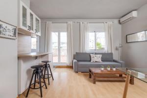 a living room with a couch and a table at Penthouse Camp Nou in Barcelona