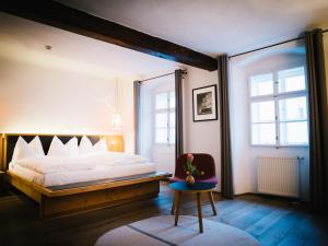 a bedroom with a large bed and a window at artHotel Blaue Gans in Salzburg