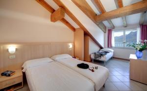 Postel nebo postele na pokoji v ubytování Hotel Residence Zust