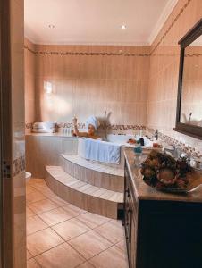 a child in a bath tub in a bathroom at Open House Boutique in Manzini