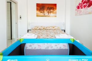 a bed with a blue frame in a room at A Casa Vostra in Sanremo +31 photos
