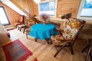 a dining room with a blue table and chairs at Camping & Glamping Jezersko ex Cvet Gora in Zgornje Jezersko