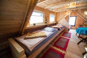 a bedroom in a log cabin with two beds at Camping & Glamping Jezersko ex Cvet Gora in Zgornje Jezersko