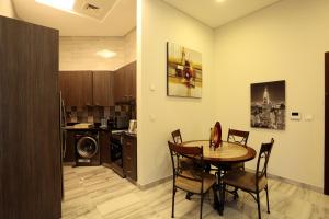 a kitchen and dining room with a table and chairs at Marbella Holiday Homes in Dubai