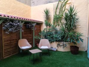 a green lawn chair sitting in front of a patio at Hôtel Jaures in Toulon