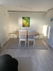 a dining room with a table and chairs at Surf Apartment Stormgade in Hvide Sande