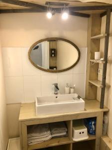 a bathroom with a sink and a mirror at Duplex La Ciotat - superbe 85 m2 - 6 pers - 3 chambres - Climatisation - Vue mer et proche du vieux port La Ciotat in La Ciotat