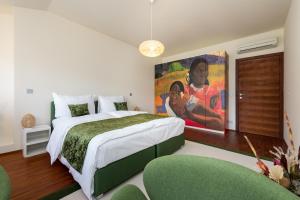 a bedroom with a large bed with a painting on the wall at Empirent Boutique Apartments in Prague
