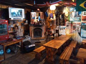 a room with a wooden table and a fireplace at Annimatsi Camping in Otepää