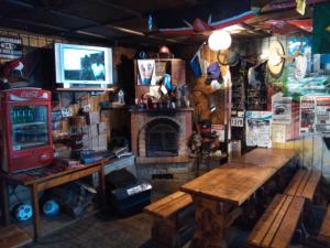 a room with a fireplace and a table and a tv at Annimatsi Camping in Otepää