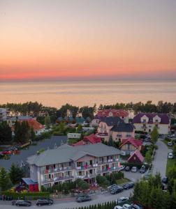 an aerial view of a town with cars parked in a parking lot at Srebrne Tarasy in Sarbinowo