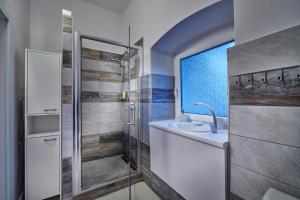 a bathroom with a sink and a shower at Apartmán BB centrum in Banská Bystrica