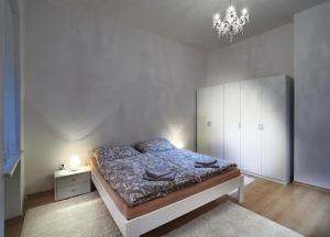 a bedroom with a bed and a chandelier at Apartmán BB centrum in Banská Bystrica