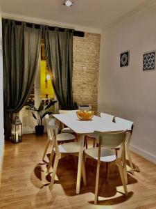 a dining room with a white table and chairs at València Experience Apartment in Valencia