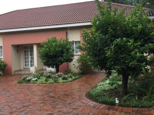 a house with a brick driveway in front of it at Welcome Guest House in Vereeniging