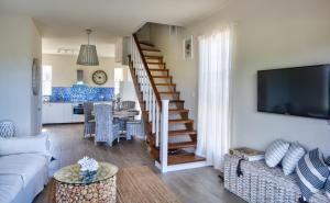 a living room with a couch and a tv at West Rock Villas in Saint James