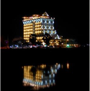 a large building with lights on it at night at Classy Hotel in Battambang