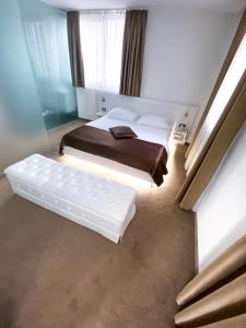 a bedroom with two beds and a window at Hotel National in Zagreb