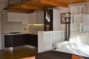 a kitchen with white cabinets and a counter top at Locanda Dal Sor Francesco in Vetralla