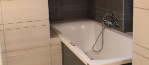 a bath tub with a shower head in a bathroom at Locanda Dal Sor Francesco in Vetralla