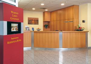 a waiting area in a hospital lobby with a counter at Residenz & Hotel Am Kurpark in Schlangenbad