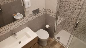 a bathroom with a toilet and a sink and a shower at THAT'S AMORE FIUMICINO Airport in Fiumicino +27 photos
