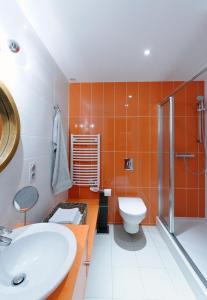 a bathroom with a white sink and a toilet at Appartement Quai N° 5 in Strasbourg