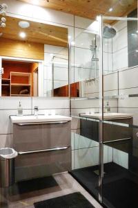 a bathroom with two sinks and a shower at CHALET HOTEL La TUVIERE BIKE INN in Saint-Jean-de-Maurienne