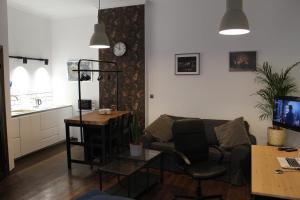 a living room with a couch and a table at Apartamenty Gołębia 3 in Krakow