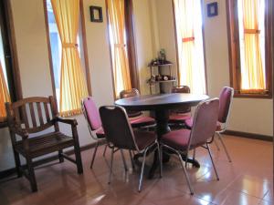 a dining room with a table and chairs at Diva House in Denpasar