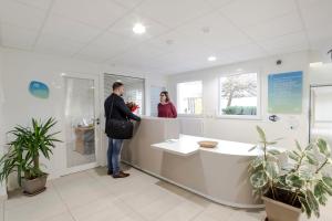 two people standing at a counter in a pharmacyacistacist at Centre Jean XXIII in Annecy