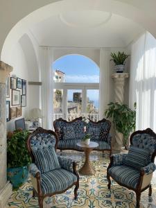 a living room with couches and a large window at Hotel Marina Riviera in Amalfi