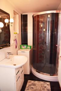a bathroom with a shower and a sink at Хостел в Карпатах in Yasinya +35 photos