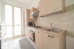 a kitchen with a sink and a stove at Carola's Home - Goelba in Portoferraio