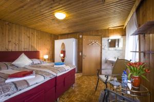 a bedroom with a large bed and a bathroom at Haus Geigenmacher in Hopfgarten im Brixental