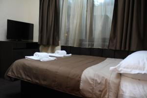 A bed or beds in a room at Guest house VRAZHDEBNA