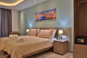 a bedroom with a large bed and a television at Lokali Rooms in Il-Gżira