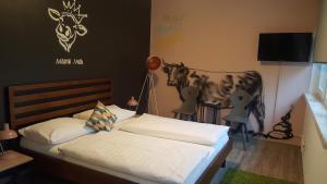 A bed or beds in a room at Mama Muh Self-Check-in