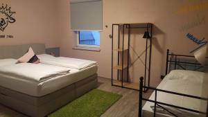 A bed or beds in a room at Mama Muh Self-Check-in