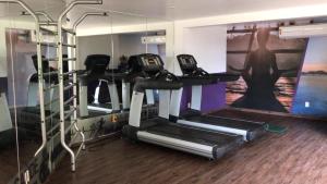 Un gimnasio con tres máquinas de correr en una habitación. en Angra dos Reis Apartamento com Vista para o Mar 6 Condomínio Porto Bali Complexo Mercure, en Angra dos Reis