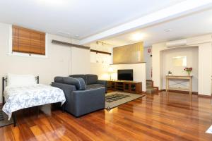 a living room with a couch and a bed in it at Fremantle Bed & Breakfast in Fremantle