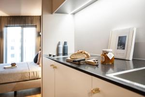 a kitchen with a counter top with a sink and a counter top at ipartment Frankfurt Airport in Frankfurt