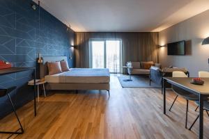 a bedroom with a bed and a living room at ipartment Frankfurt Airport in Frankfurt