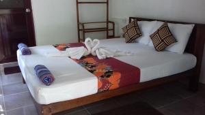 a bed with a bow on top of it at Green Village Homestay in Dambulla