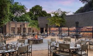 a large outdoor dining room with tables and chairs at Protea Hotel by Marriott Kruger Gate in Skukuza