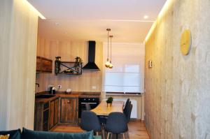 a kitchen with a table and chairs in a room at Epoca in Sila in Camigliatello Silano