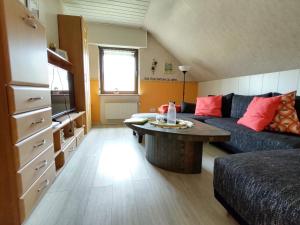 a living room with a couch and a table at Die Ferienwohnung Lindenhof in Zell an der Mosel