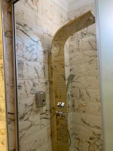a shower in a bathroom with a stone wall at Riad Dar El Mesk in Rabat